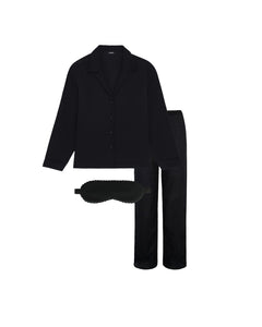 Black pajama set with matching eye mask on a white background