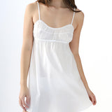 White slip dress worn by a model on a white background