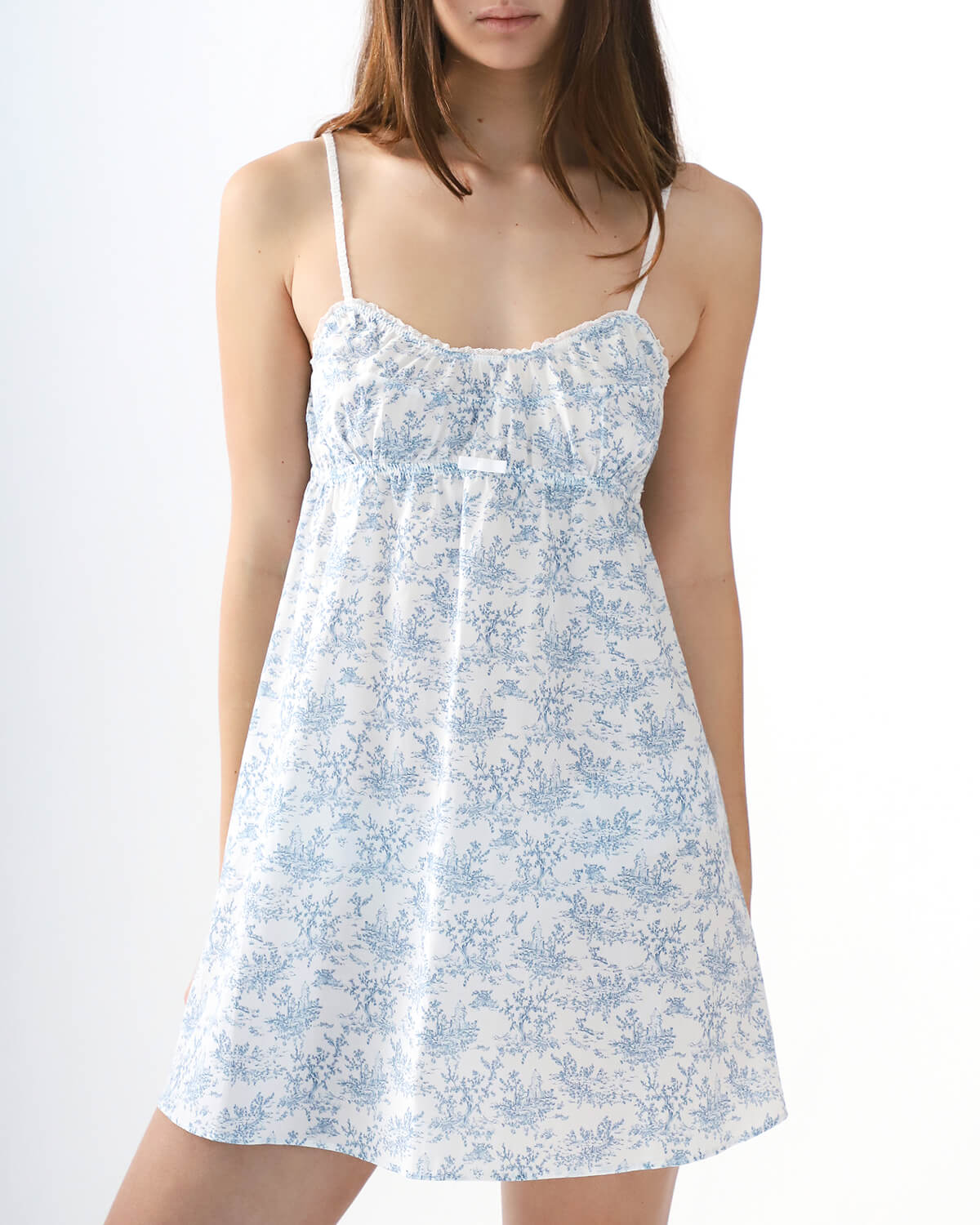 Woman wearing a blue floral dress on a white background