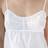 White lace-trimmed top worn by a person