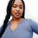 Woman wearing a blue shirt against a white background