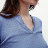 Close-up of a person wearing a blue patterned top on a white background