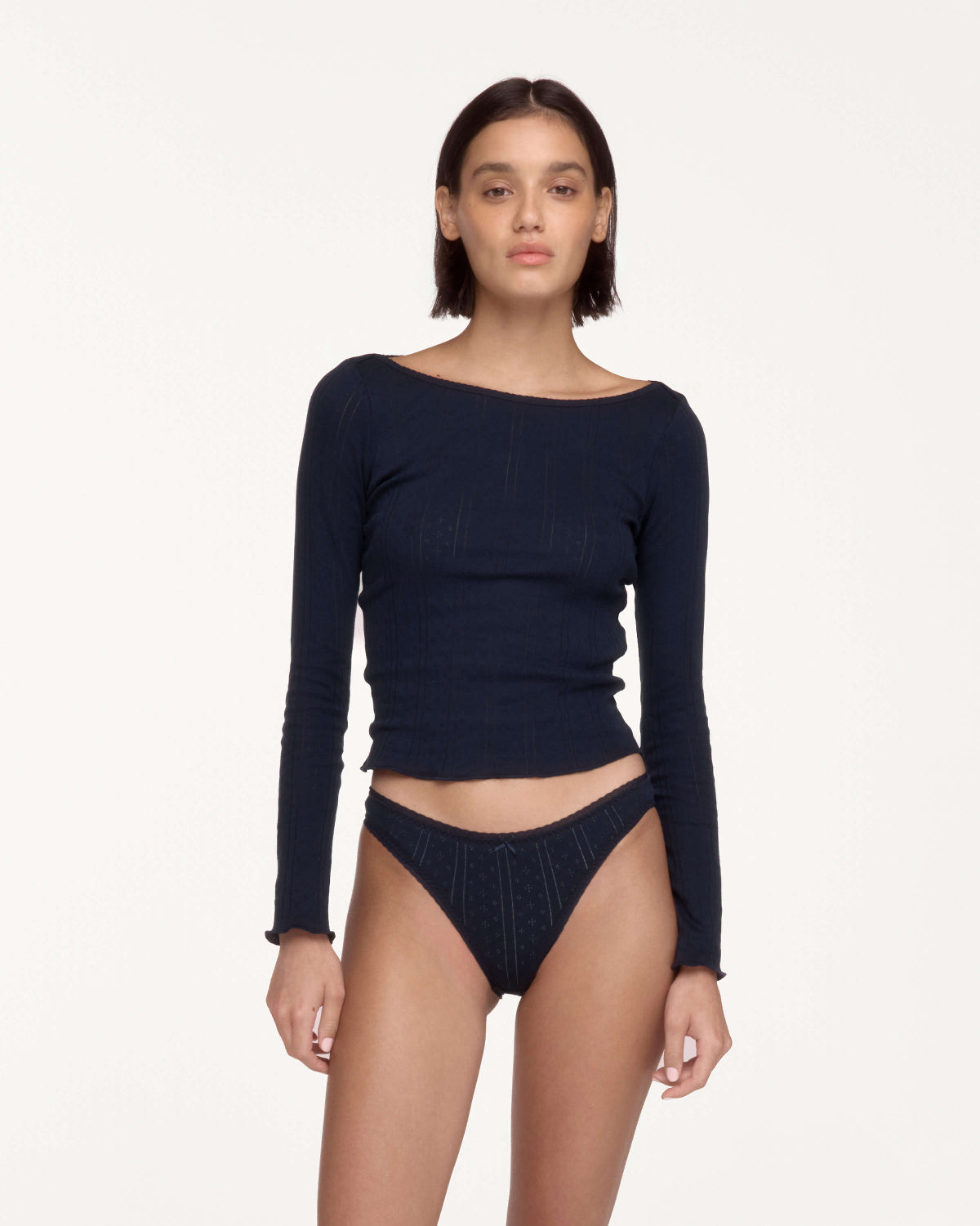 A model wearing a dark navy blue long-sleeve top.