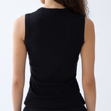 Person wearing a black sleeveless top on a white background