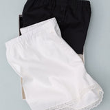 Black and white shorts with lace trim on a light gray background