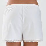 White lace-trimmed shorts on a plain background