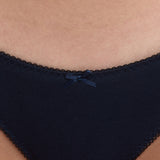 Close-up of a person wearing dark navy underwear with a small matching bow at the center front.