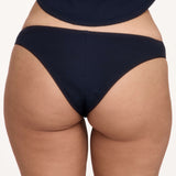 Rear view of a model wearing dark navy blue underwear