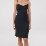 Woman wearing black slip dress.