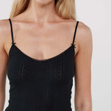 Black slip dress worn by a person on a white background