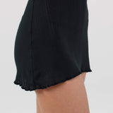 Black skirt with ruffled hem on a white background