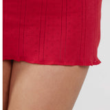 Close-up of a red textured skirt on a white background