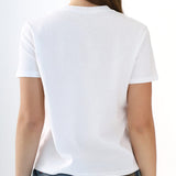 Person wearing a plain white t-shirt on a white background