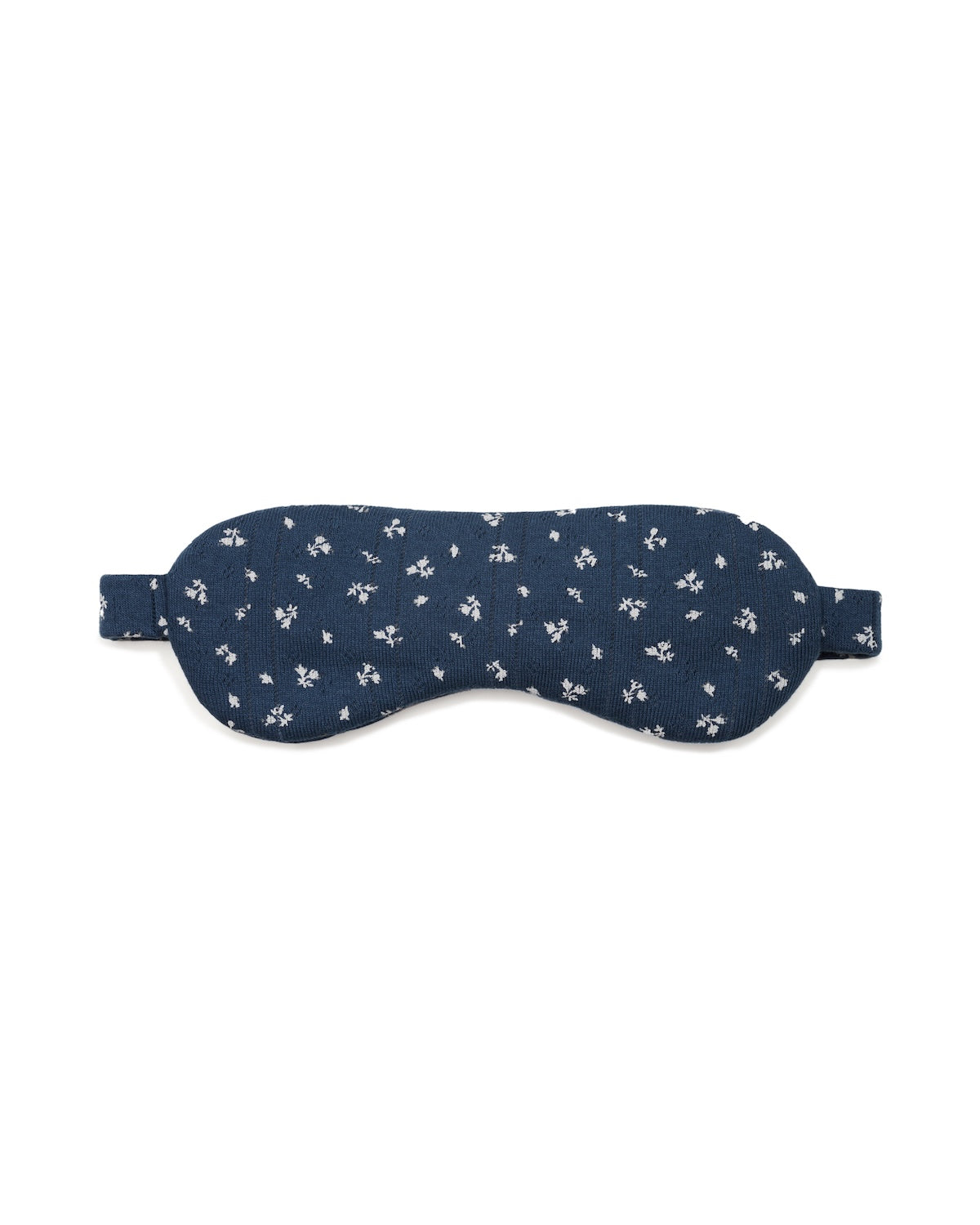 Navy sleep mask with white floral pattern on a white background