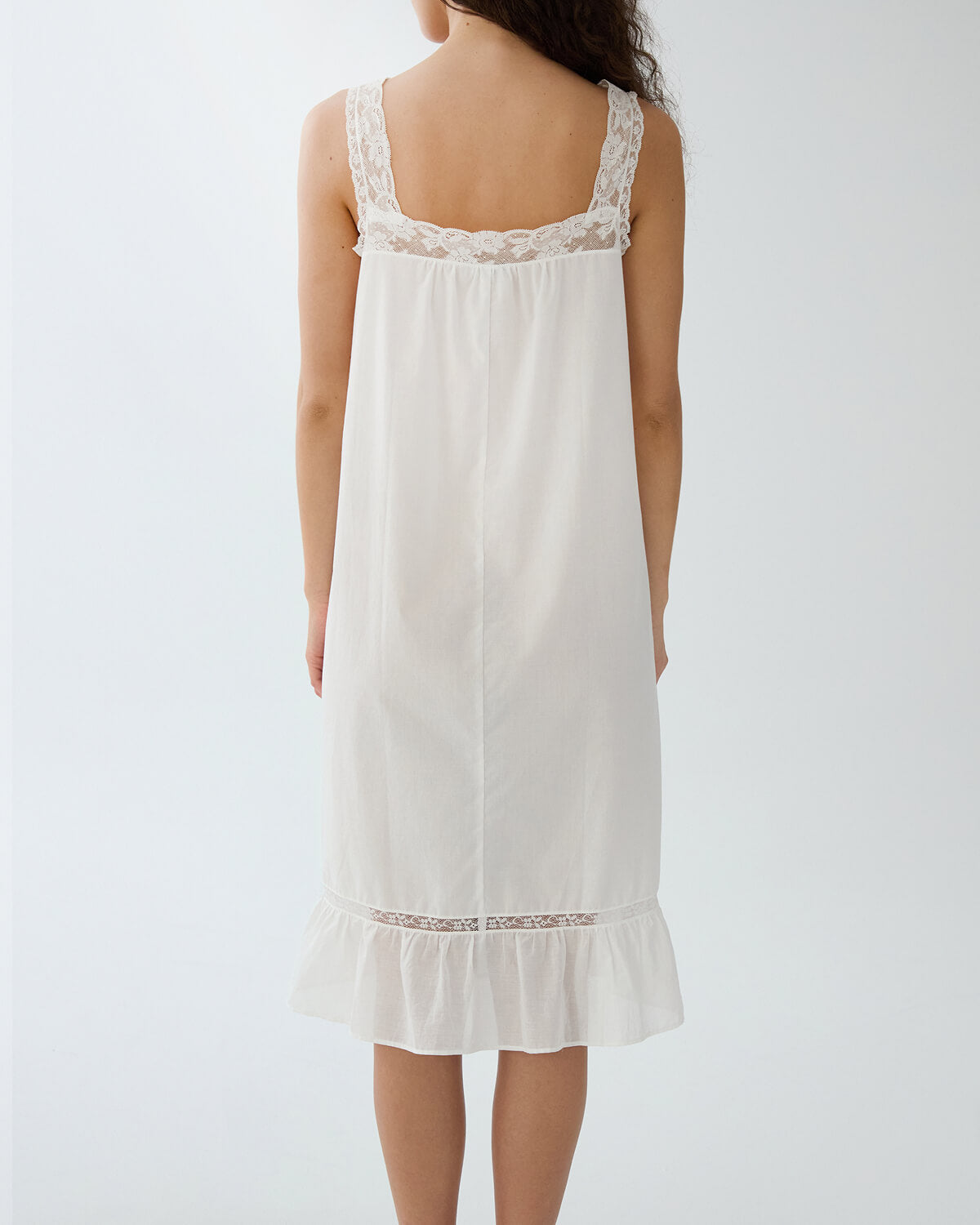 White lace-trimmed nightgown on a plain background