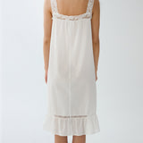 White lace-trimmed nightgown on a plain background