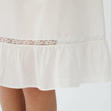 White lace-trimmed dress on a white background