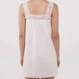 White lace-trimmed nightgown on a plain background
