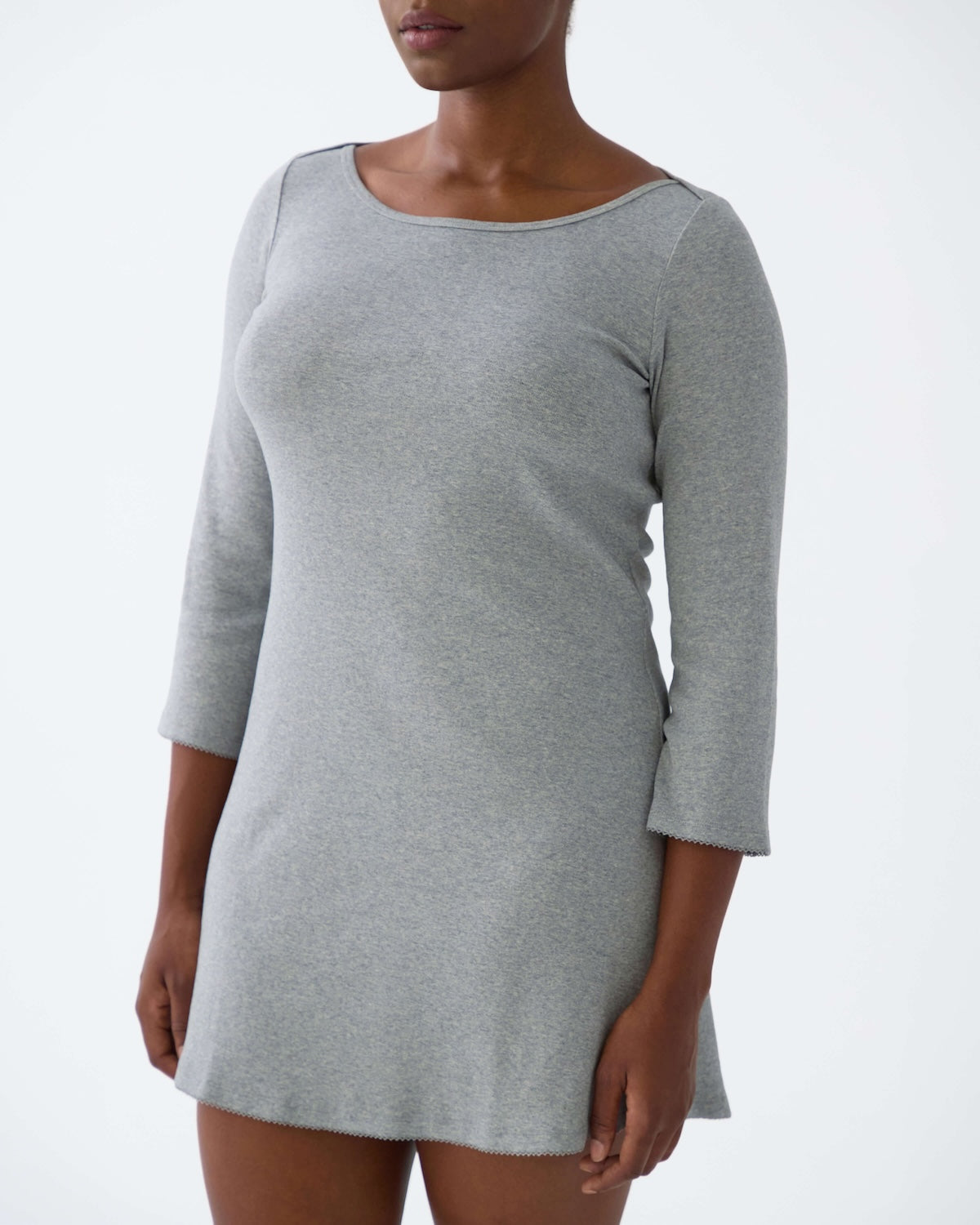 Gray dress worn by a person on a white background