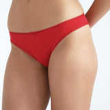 Red brief worn by a person on a white background