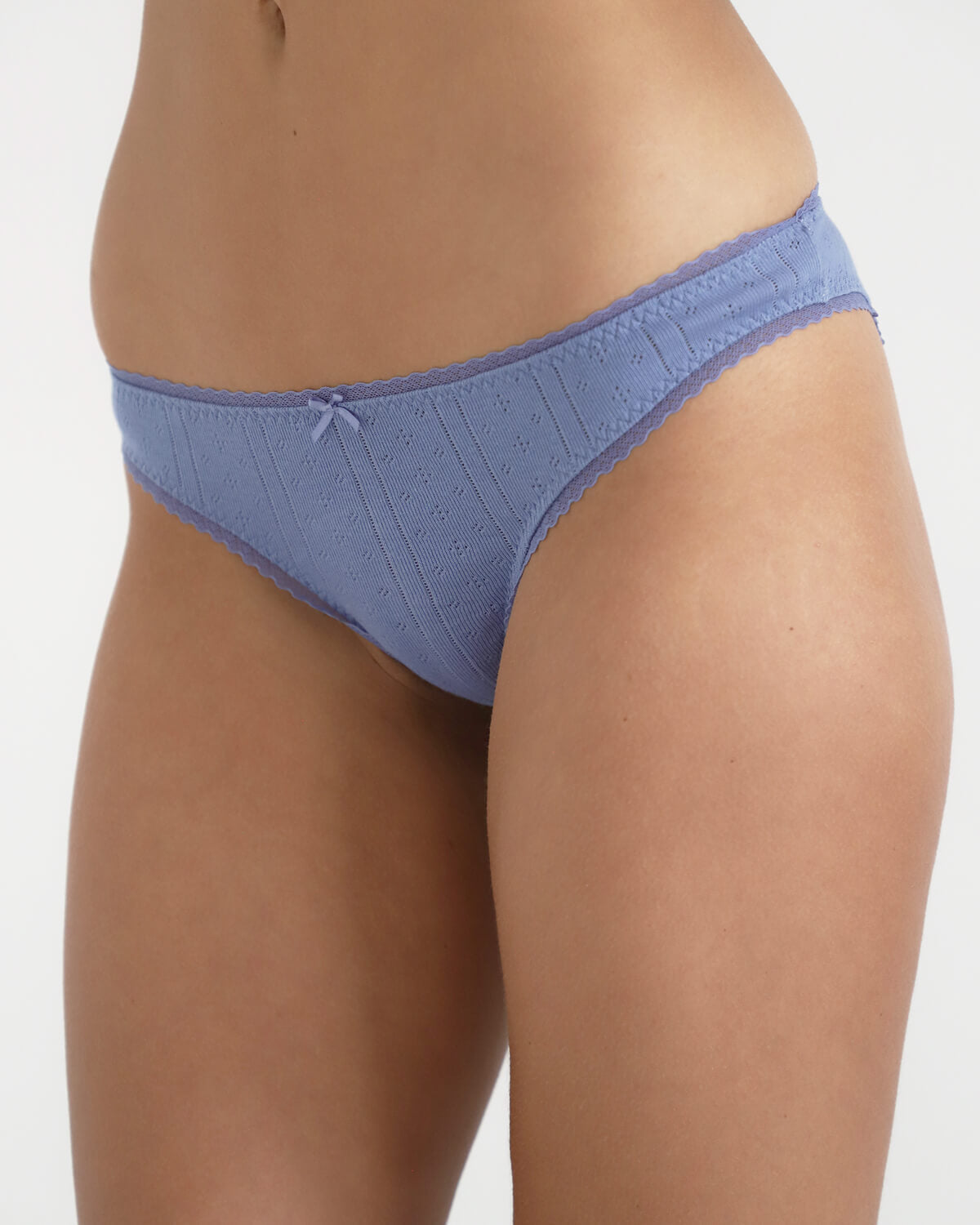 Blue underwear worn by a person on a white background