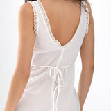 White sleeveless dress with lace details on a white background