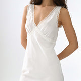 White slip dress with lace details on a white background