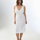 Woman wearing a white dress on a plain background