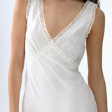 White sleeveless top with lace detailing on a white background