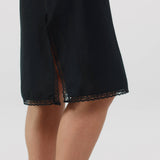 Black dress with lace trim on a white background