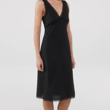 Black dress worn by a model on a white background