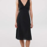 Black dress with lace details on a white background