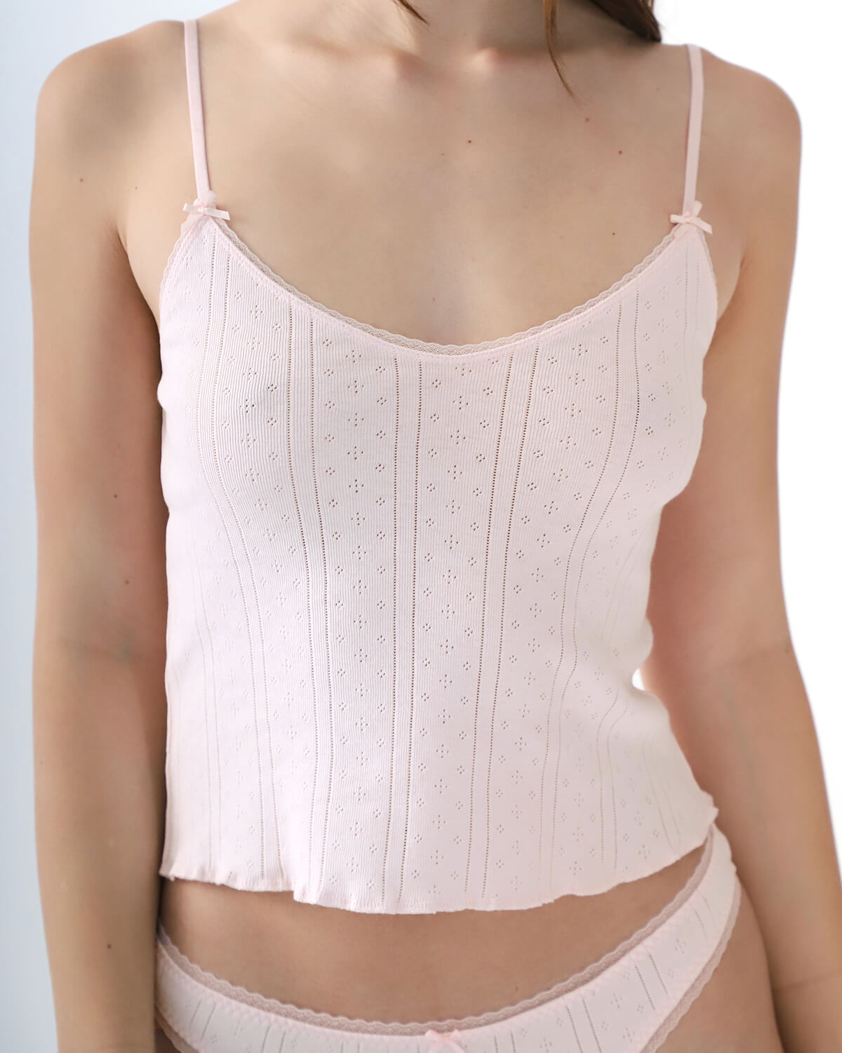 Light pink camisole worn by a person on a light gray background