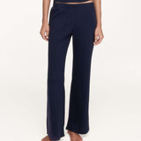 A model wearing a pair of dark navy blue pants, shown from the waist down against a plain white studio background.