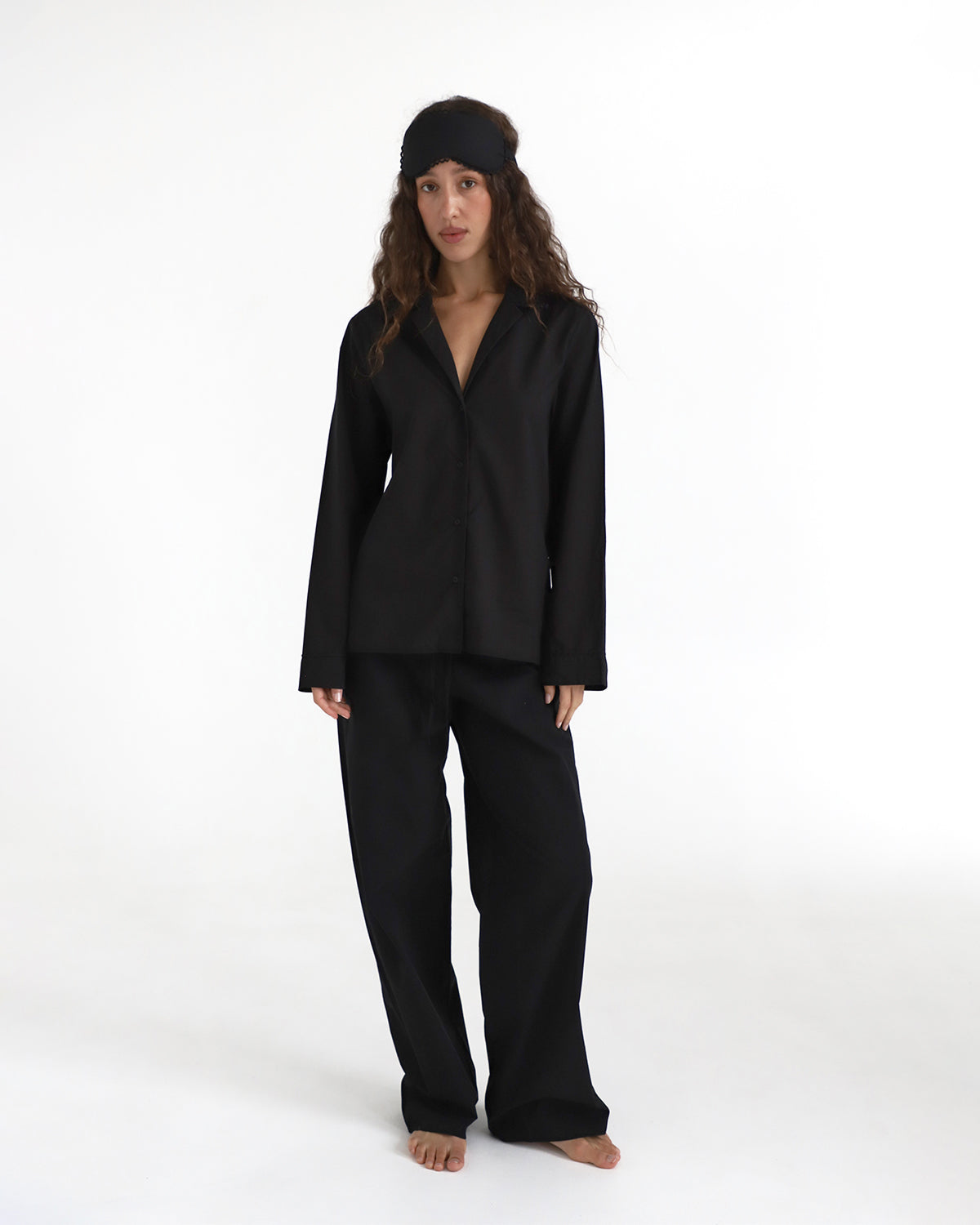 Woman wearing a black outfit on a white background