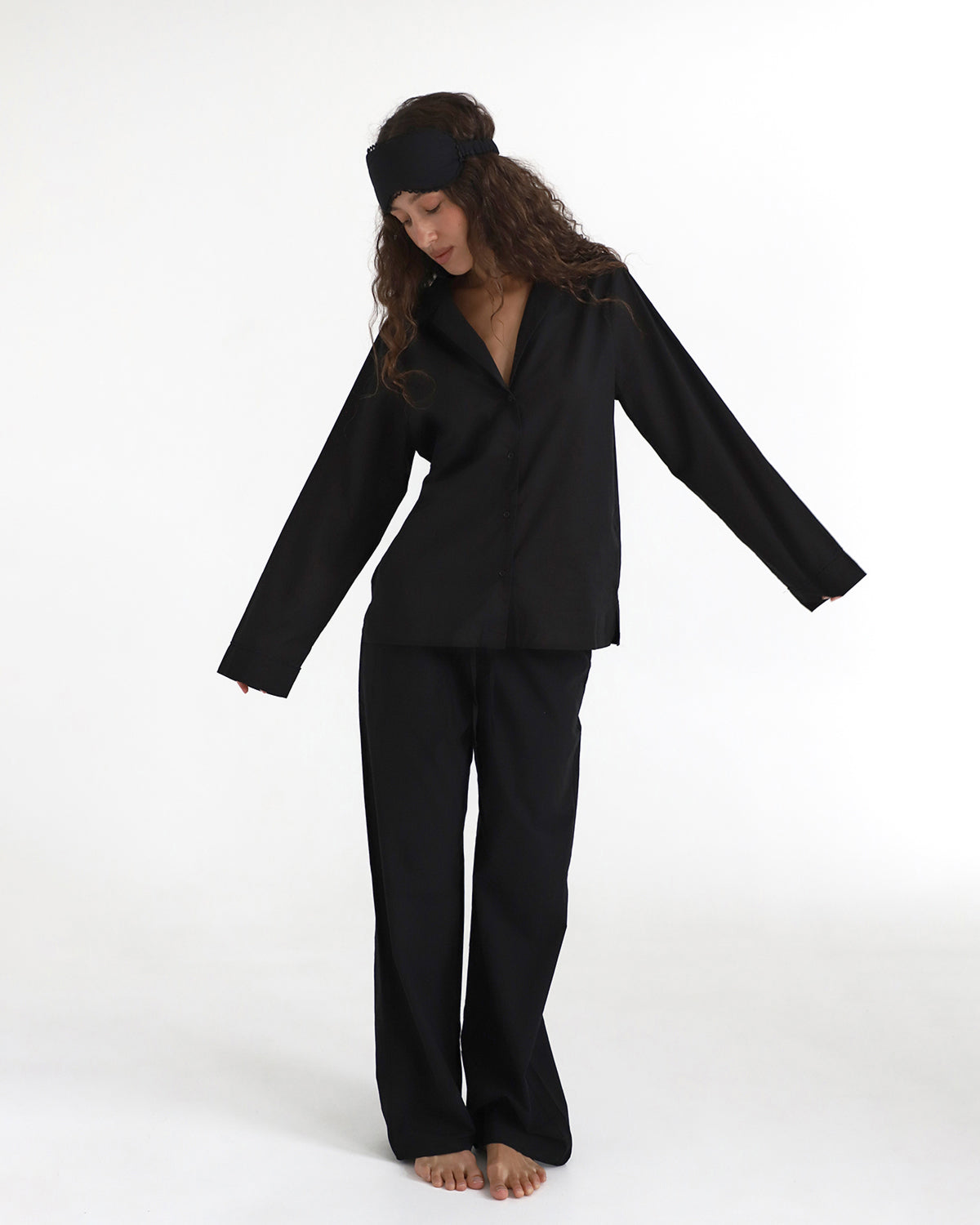 Person wearing a black outfit on a white background