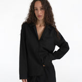 Woman wearing a black outfit on a white background