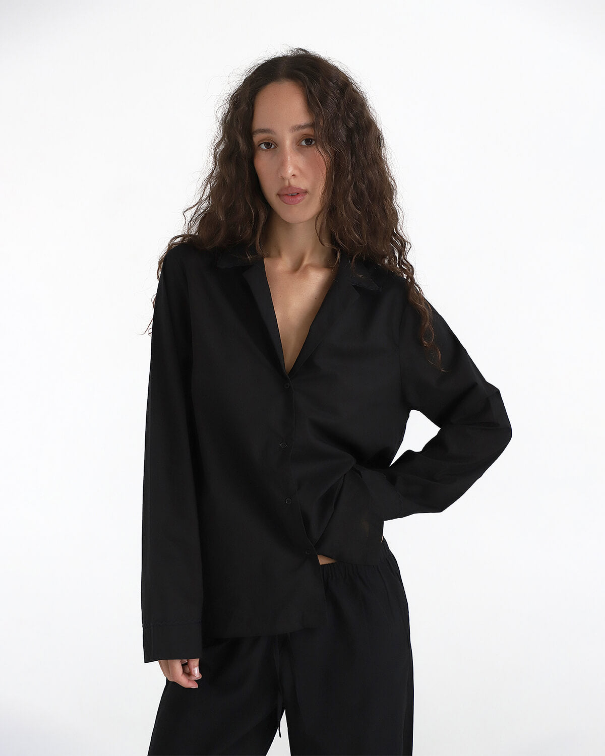 Woman wearing a black outfit on a white background