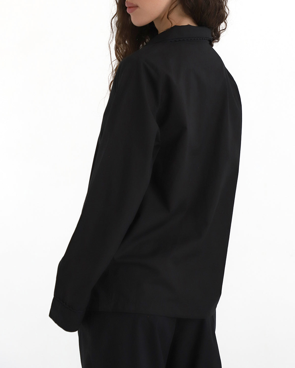 Person wearing a black outfit on a white background