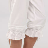 White satin nightgown with ruffled hem on a plain background