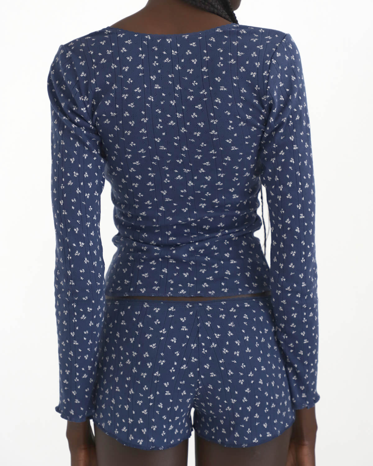 Blue patterned long-sleeve top and shorts set on a white background