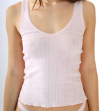 Pink tank top worn by a model on a plain background