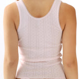 Pink tank top and thong worn by a person on a white background