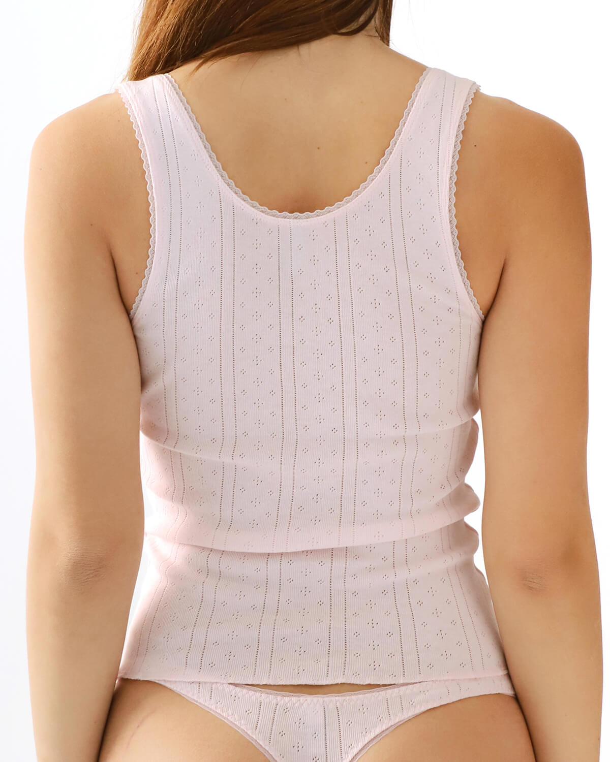 Pink tank top and thong worn by a person on a white background