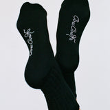 Black socks with white text on a light gray background