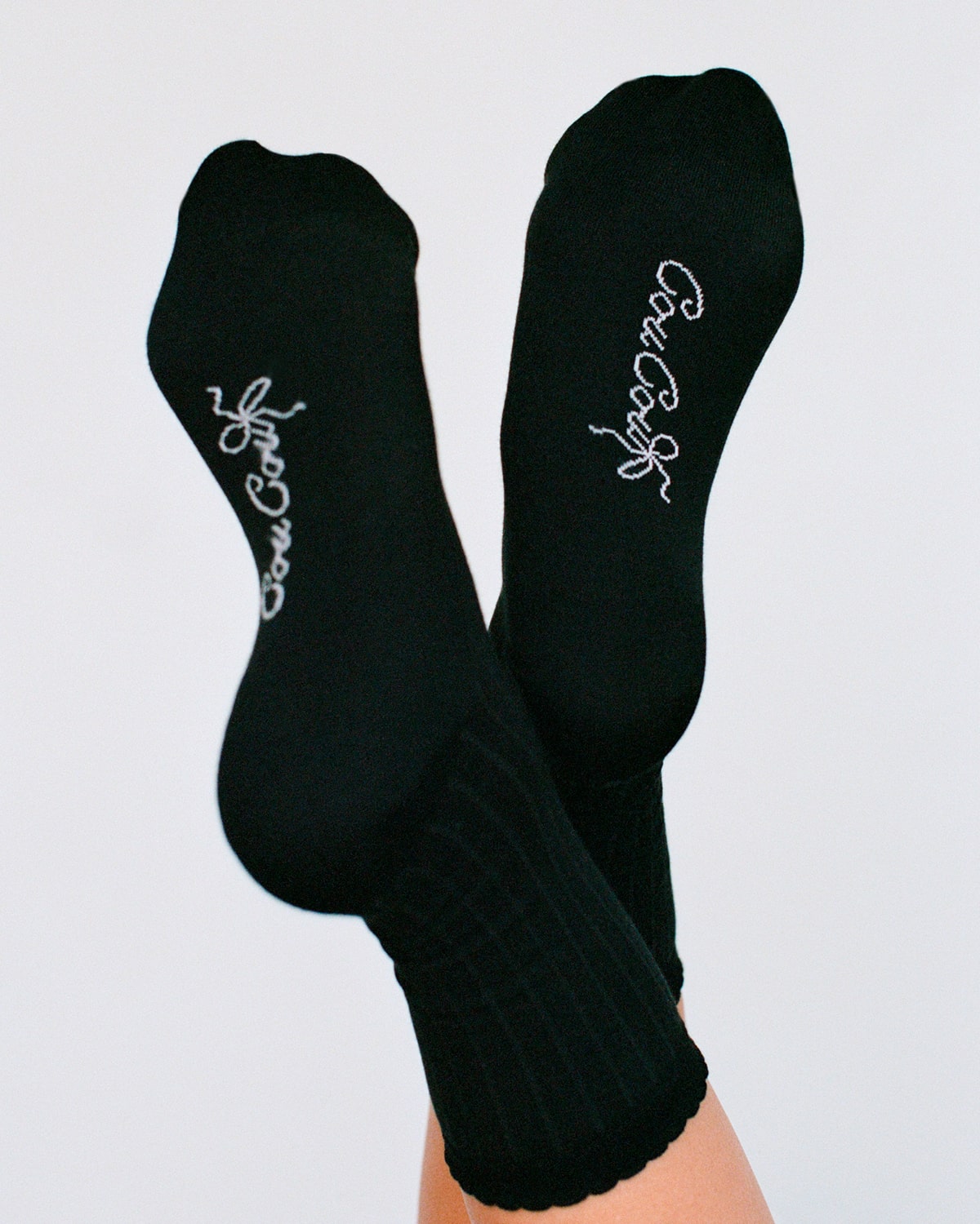 Black socks with white text on a light gray background