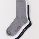 Three socks in gray, white, and black with Cou Cou branding on a light gray background.