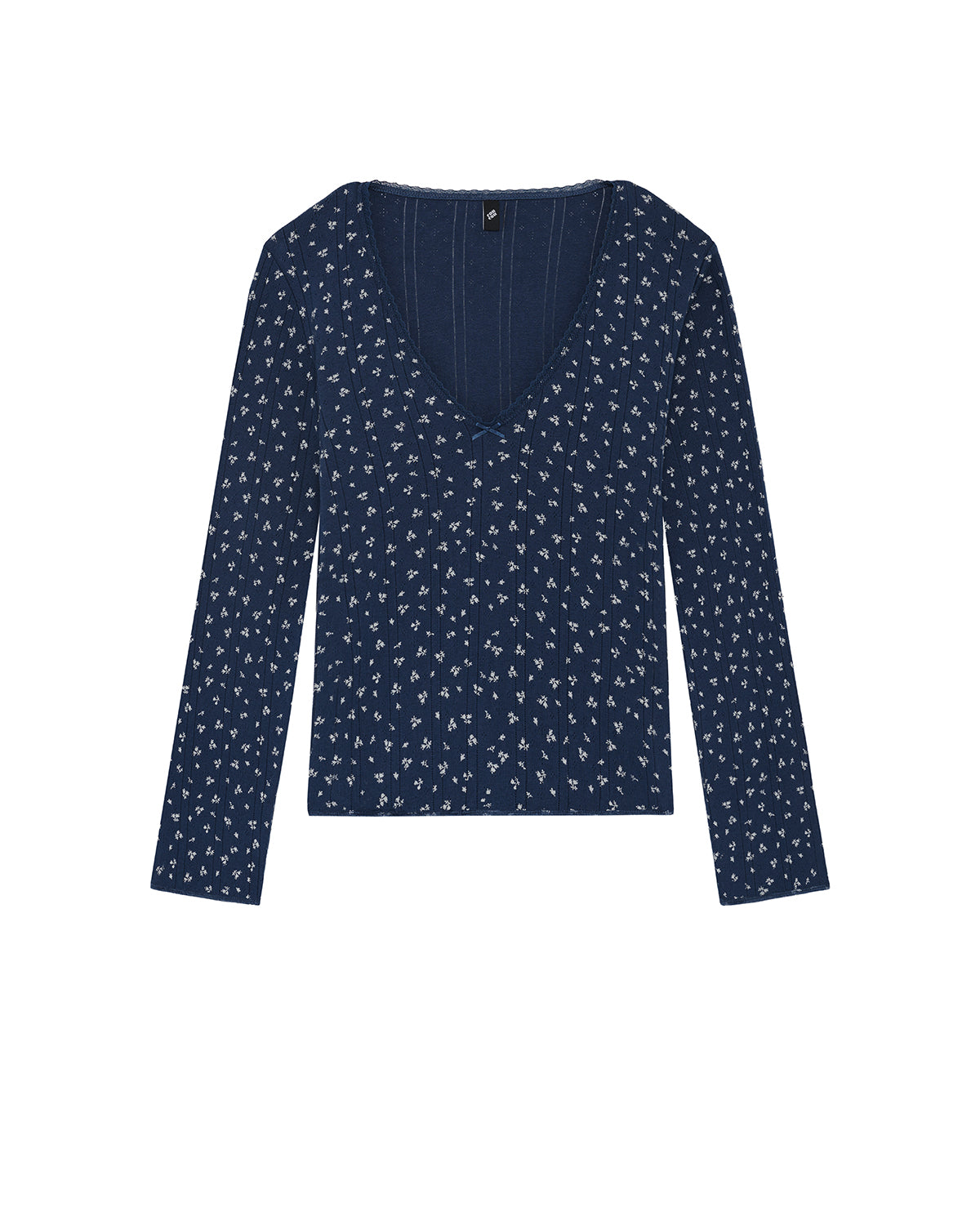 Navy blue long-sleeve top with small white pattern on a white background