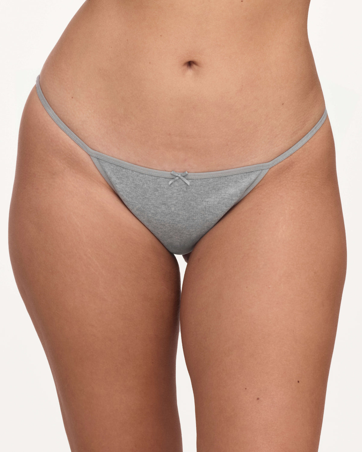A close-up of a model wearing a light gray underwear with a small bow detail at the center front, set against a plain light background.