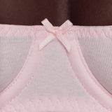 Close-up of a light pink bra and underband with a small bow detail.